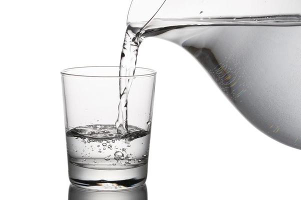 Clean water being poured in glass - Filter Drinking Water concept image
