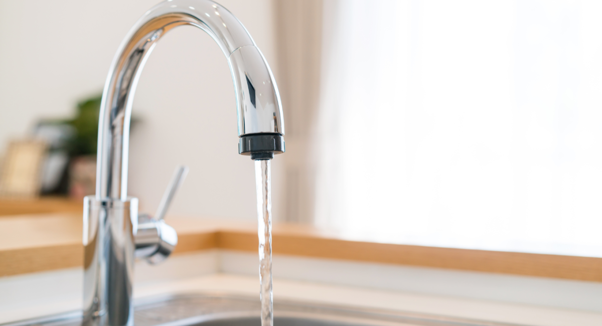 water pouring from tap - Lead In Drinking Water concept image